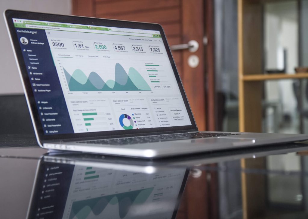 laptop on desk showing analytics